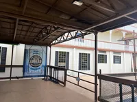 The image shows an outdoor covered walkway with a large banner hanging that reads