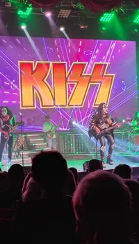 A band performs on stage in front of a large 