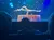 A contortionist performs a complex balancing act on a stage with a starry backdrop, watched by an audience.