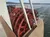 A red paddlewheel is seen on a riverboat cruising along a body of water.