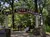The image shows the entrance to White River Landing with people walking and sitting on a pathway surrounded by trees.