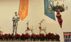 The image features a room with colorful draped banners, a knight statue, decorative reindeer, festive red ornaments, and a chandelier.