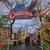 A festive archway adorned with colorful lights welcomes visitors to 