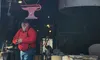 The image shows a man standing outside 