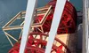 The image shows the red paddle wheels of a riverboat protruding over a body of water.
