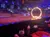 A flame-lit ring occupies a central stage area in an arena, with a dining setup in the foreground and an audience in the background.