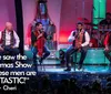 Four men are performing on stage during a Christmas show with colorful lights and festive decorations in the background