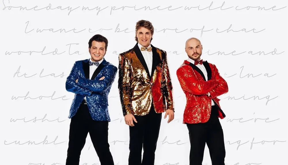Three smiling men are dressed in colorful sequined jackets posing confidently against a white background with cursive handwriting