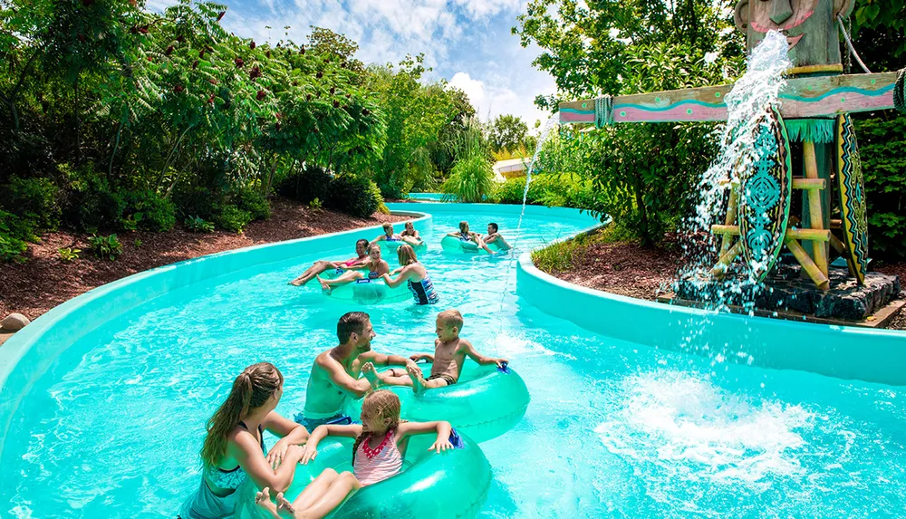 People are enjoying a leisurely ride on a water parks lazy river under a sunny sky
