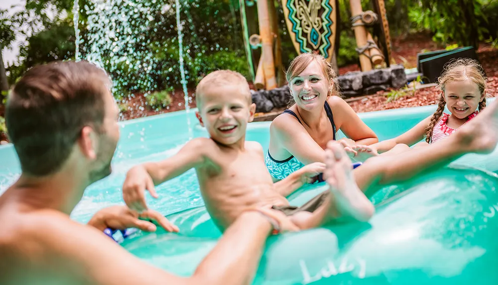A family is enjoying their time together in a pool smiling and having fun