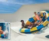 A group of people are enjoying a ride on an inflatable raft down a water slide with an inset showing a person smiling on a single-person tube