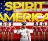 The image features a group of performers in red costumes and a naval officer in front of an American flag backdrop with the text SPIRIT OF AMERICA and a partial view of the Statue of Liberty