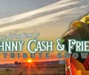 The image is a promotional graphic for Dan Wagners Johnny Cash  Friends Tribute Show featuring a performer with a guitar set against a backdrop of a train and sunset
