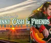 The image is a promotional graphic for Dan Wagners Johnny Cash  Friends Tribute Show featuring a performer with a guitar set against a backdrop of a train and sunset