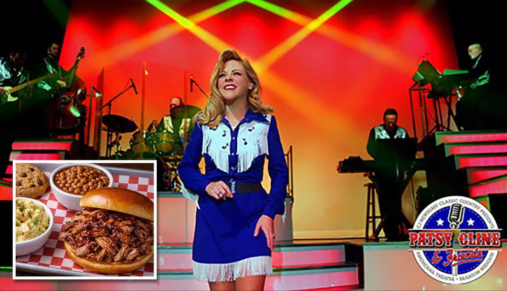 A performer in a blue and white outfit sings on a stage with a band in the background illuminated by colorful stage lights