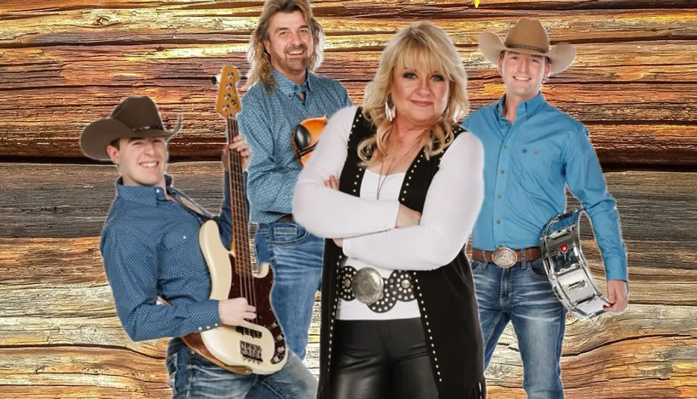 Four people in western attire pose in front of a wooden backdrop with two holding musical instruments