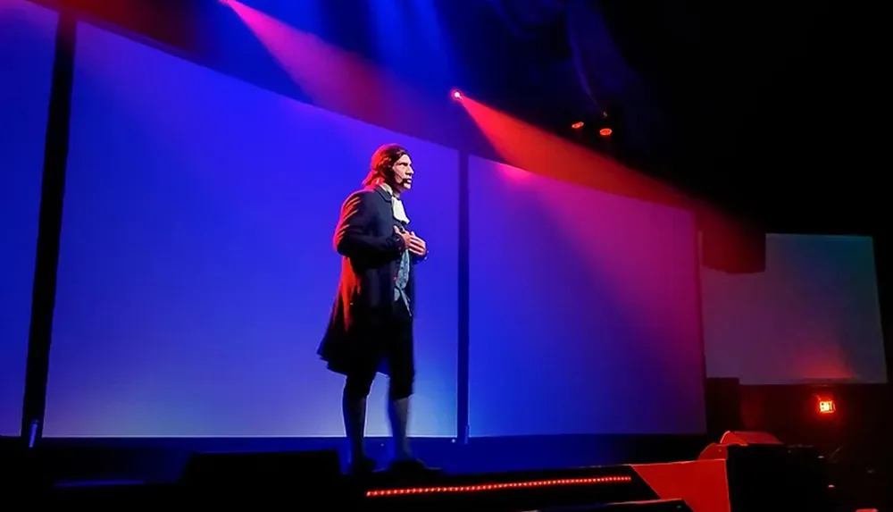 A person dressed in historical clothing performs on a stage under colorful red and blue lighting