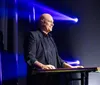 A person skillfully fans a deck of cards accompanied by a glowing review saying World-Class Magic from the Las Vegas Review Journal