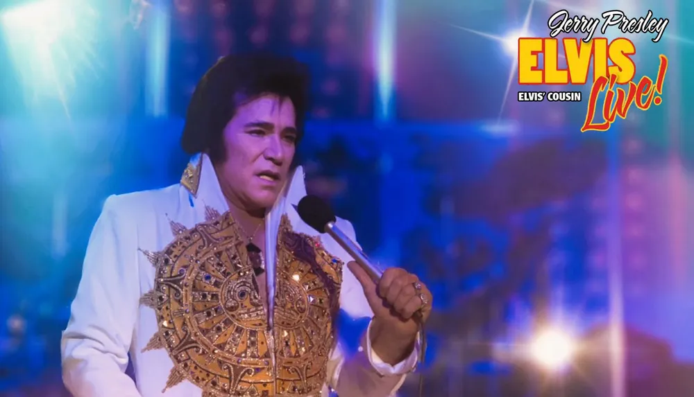 The image shows a performer dressed in a white and gold embellished outfit holding a microphone on stage with the text Jerry Presley Elvis Cousin Live in the background