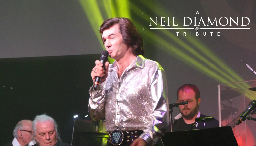 A man in a sparkling silver shirt performs on stage during a Neil Diamond tribute concert
