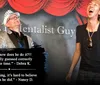 Two people are on a stage with one wearing a sparkly jacket and the other laughing in front of a backdrop that says THA Mentalist Guy with red curtains above