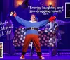 A festive stage performance features a person dressed in a Santa-themed outfit with outstretched arms surrounded by Christmas decorations and graphics promoting a holiday show