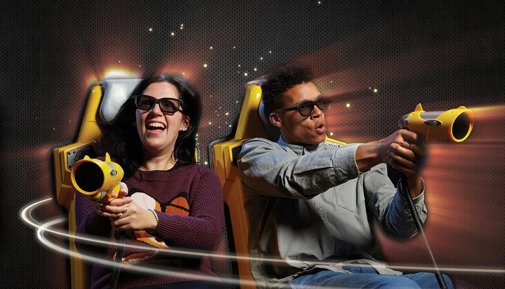 Two people wearing 3D glasses are enthusiastically playing an interactive game with toy guns in a dynamic setting