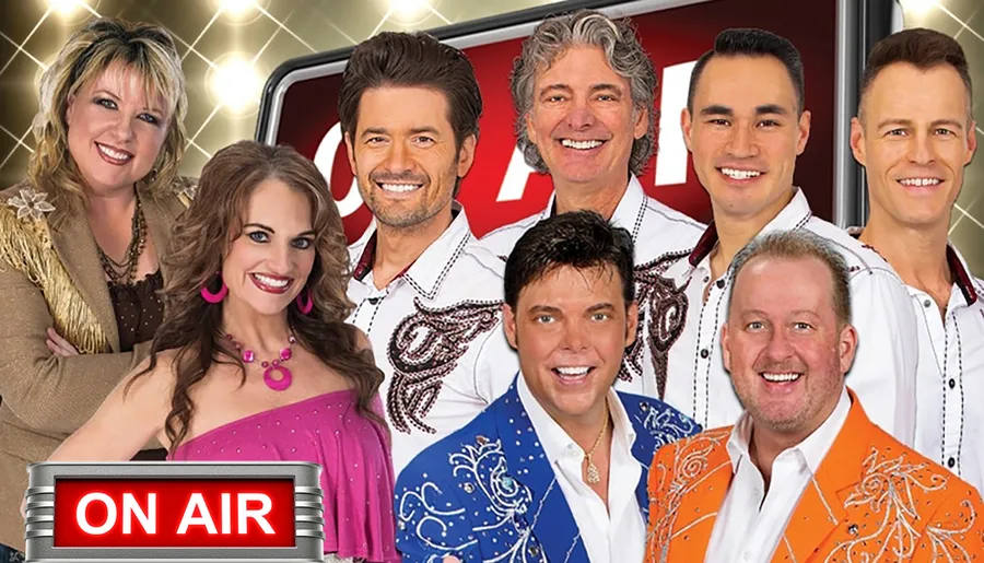 This image features a group of eight smiling people in colorful clothing, posed together, with an As Seen on TV graphic, suggesting they might be part of a television show or advertisement.