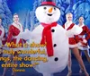 A person in a snowman costume is surrounded by smiling dancers in festive outfits on a winter-themed stage