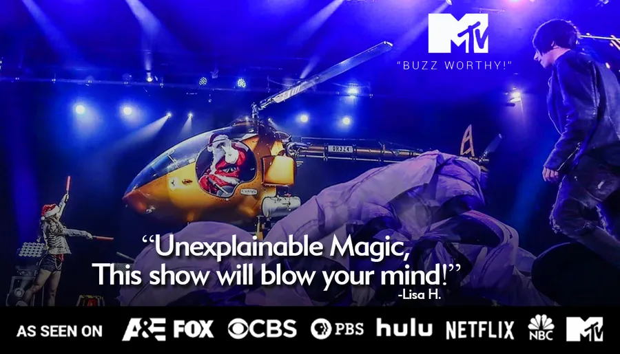 The image shows a staged performance featuring a helicopter and performers under dramatic lighting, with a quote praising the show's magic, and logos from various media outlets including MTV, Hulu, and Netflix.