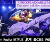 A performer stands on stage next to a helicopter with dramatic lighting a flowing fabric and a text quote praising an unexplainable magic show accompanied by logos of various networks