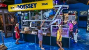 Visitors are examining a large underwater remotely operated vehicle (ROV) named ZEUS from Odyssey on display at a museum or exhibition.